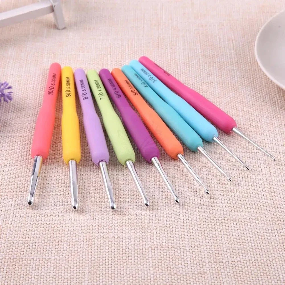 Colourful soft-grip crochet hooks arranged on a neutral surface
