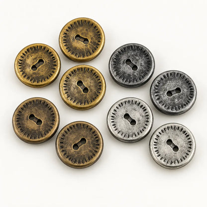 Ten vintage 18 mm metal buttons in four antique finishes on a white studio background