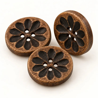 Macro view of carved dark-wood buttons showing flower carving, grain, thickness and four holes