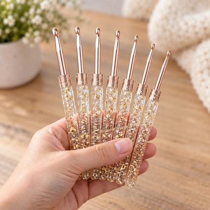 Complete 7-piece Gold Glitter crochet hook set shown at hand scale