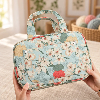 Floral crochet hook organizer case held in two hands to show its size