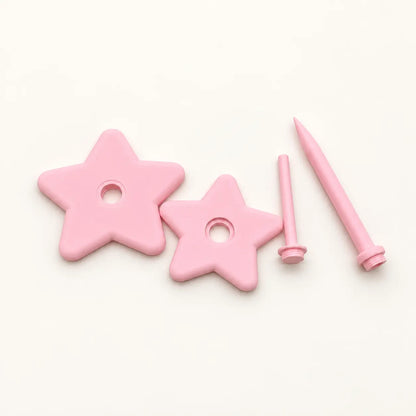 Pink rotating star yarn holder components laid out before assembly