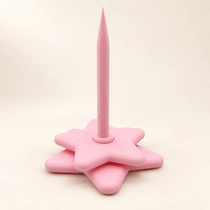 Pink rotating star yarn holder on a warm ivory background